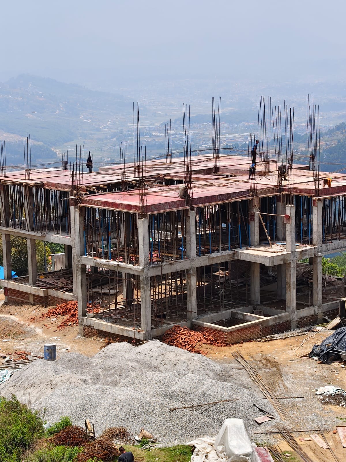 Prajwal Residency under construction — RCC frame above the Kathmandu valley.