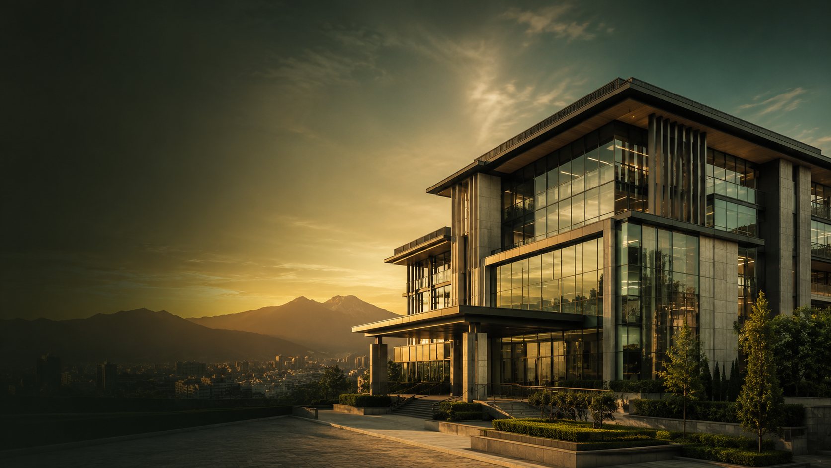 A glazed commercial building at sunset, with the Kathmandu valley and mountains beyond.